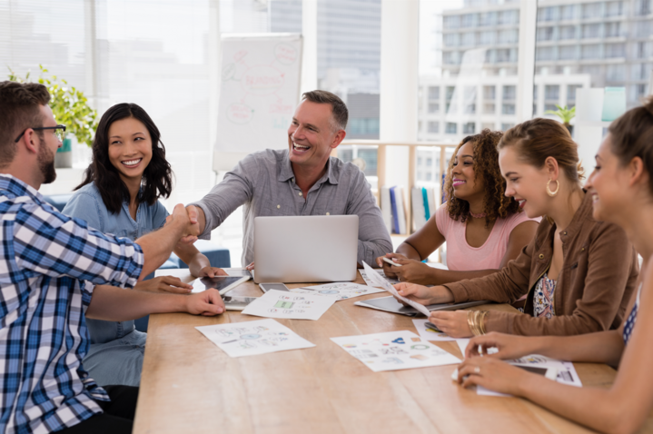 Executives shaking hands in the meeting learning what is team selling